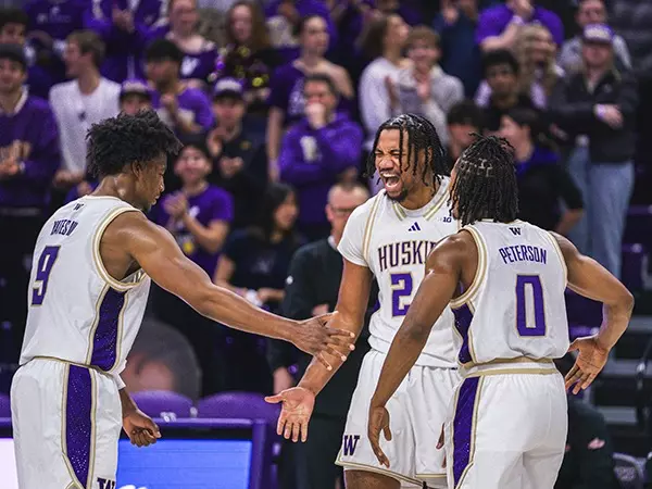 Quimari Peterson, Wesley Yates III, and Lathan Sommerville celebrate play