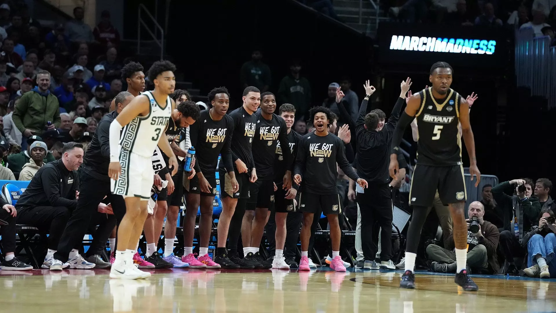 Bryant's bench celebrates a bucket in NCAA Tournament