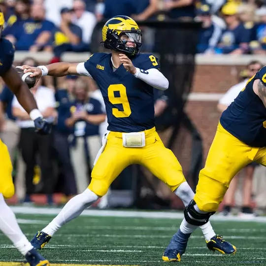 M Den selling Michigan football jerseys with players' names on the