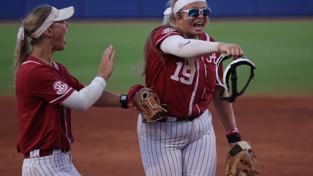 Alabama softball player Bailey Dowling (7) and Alabama softball player Kayla Beaver (19) celebrate the last out against Duke at OGE Field at Devon Park in Oklahoma City, OK on Friday, May 31, 2024.
