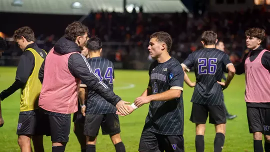 Charlie Kosakoff high fives Asher Hestad during Washington's NCAA Tournament match at Oregon State.