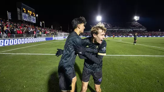 Richie Aman celebrates with Alex Hall after a goal in the national championship match against NC State.