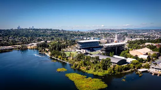 Photo of Alaska Airlines Field at Husky Stadium and UW Athletics village over Lake Washington with Seattle in background