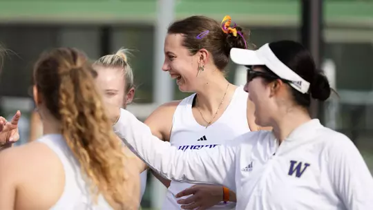 Alexia Jacobs smiles with teammates before match at Hawaii