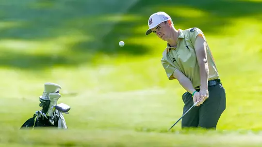 Jack Murphy chips the ball out of the rough