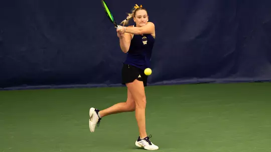 Reece Carter hits tennis ball