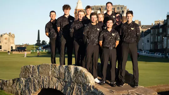 Washington men's golf team stands on the bridge at the Old Course in St Andrews, Scotland