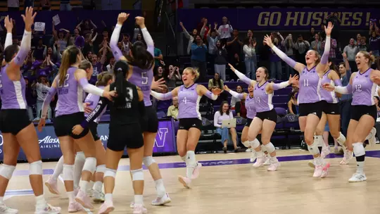 The Huskies run onto the court to celebrate the victory
