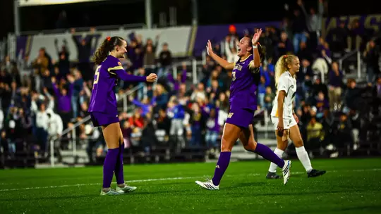 Alex Buck and Avery Nguyen celebrate Washington's winning goal in the 2-1 victory over Iowa