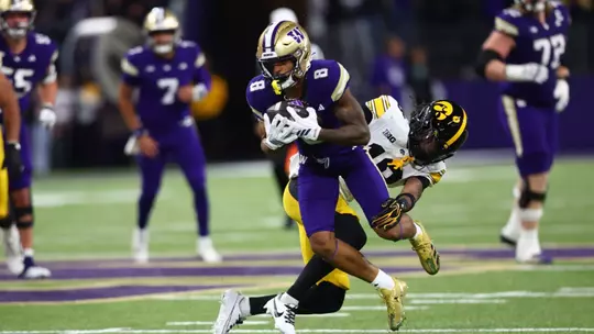 Chris Lawson tackled by Iowa defender