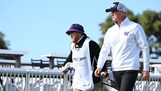 Finn Koelle walking and Alan Murray carrying a bag at the 2025 Genesis Collegiate Showcase