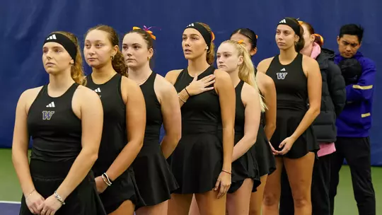 Women's tennis team stands for the national anthem