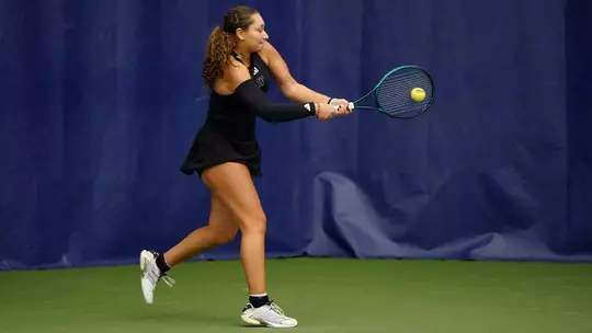 Jermine Sherif hits the ball with her racquet