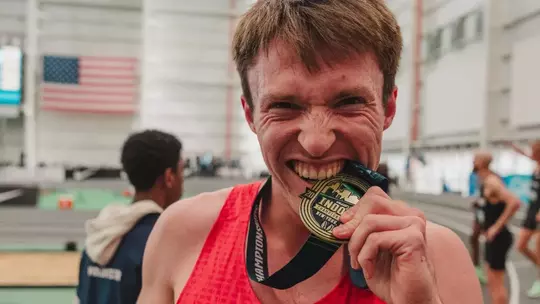 Nathan Green bites his USA Gold medal in the 2026 indoor championships