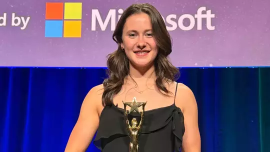 Amanda Moll posing with the Seattle Sports Star of the Year trophy