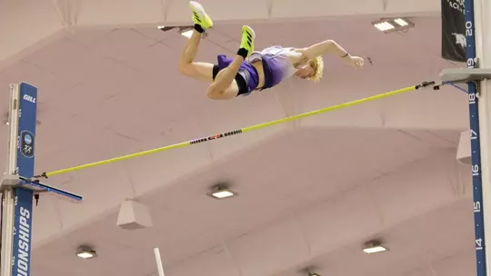 james rhoads soars over a bar in the pole vault at NCAA Indoors