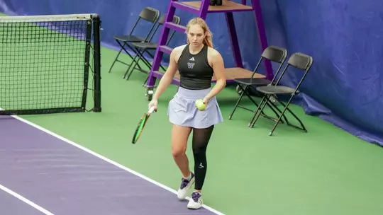 Marie Weissheim walks with a ball and raquet in hand