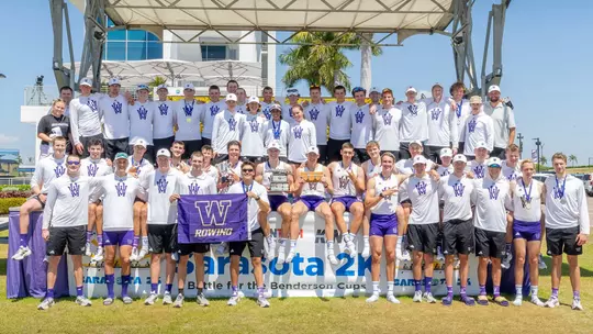 the Washington men's rowing team poses with its trophies on the podium at the 2026 Benderson Cup in Sarasota, Fla.