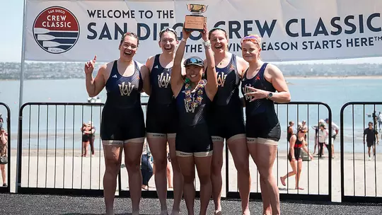 Washington women's rowing second varsity four poses with its trophy at 2026 San Diego Crew Classic
