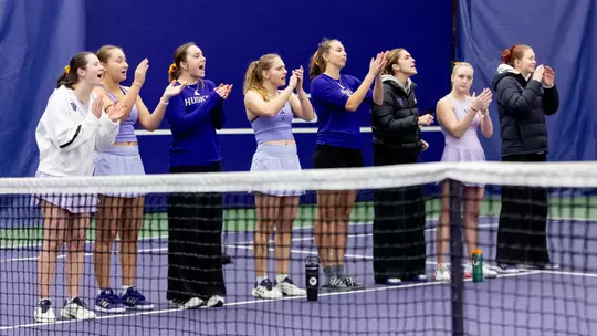 The women's tennis team celebrates a point