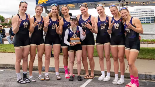members of Washington's women's rowing team varsity eight crew hold the Simpson Cup after beating California, April 11, 2026