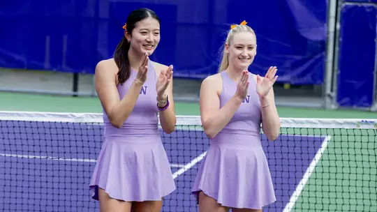 Erika Matsuda and Reece Carter clap during a pre-match senior day ceremony