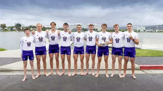 The University of Washington men's rowing team holds the Schoch Cup after beating California on April 25, 2026