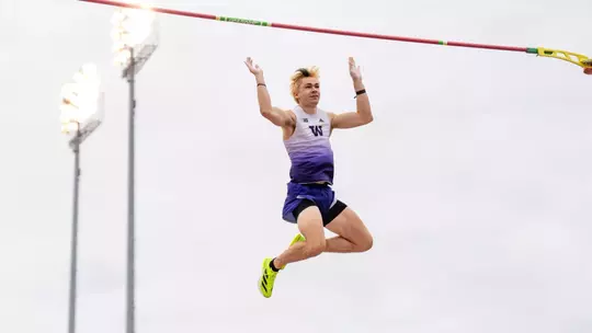 Jimmy Rhoads dropping down after clearing the pole vault bar