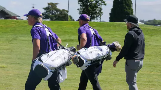 Emil Herstad and Finn Koelle walk with their bags alongside head coach Alan Murray during the final round of the NCAA Corvallis Regional