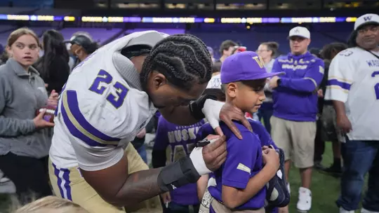 Zaydrius Rainey-Sale signing Husky fan's jersey