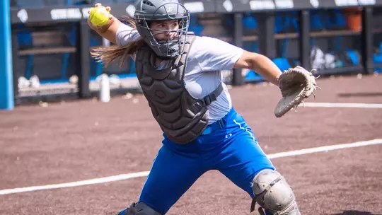 Lea Kosinski throwing in catchers gear