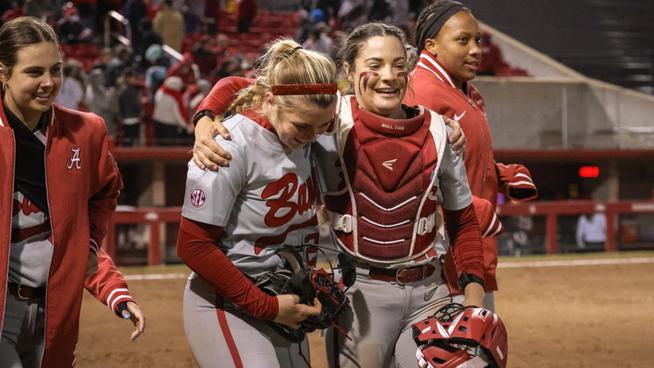 Jocelyn Briski (23) and Riley Valentine (17) embrace as they walk off the field together after a win at Arkansas (April 20, 2024)