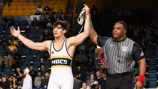 Sergio Desiante's hand is raised as the 174 champion at the Southern Scuffle