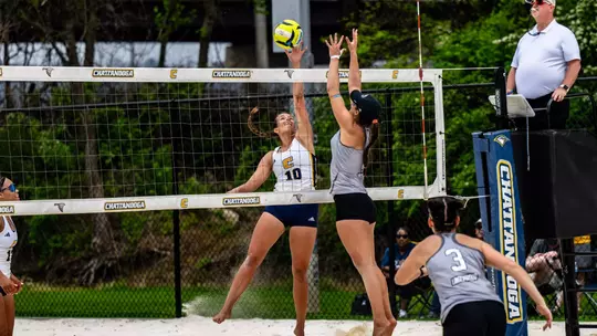 Ansley Gulledge tipping the ball over the net against Lindenwood