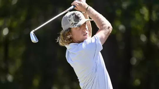 Camden Braidech holds a high finish on an iron approach to the green.