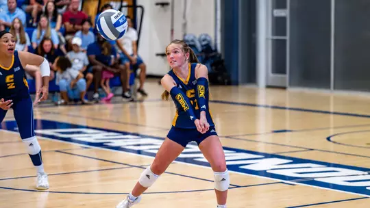 Finley Hilliard digs the volleyball against UAB