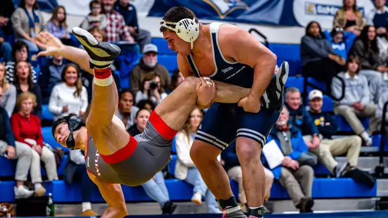Ethan Vergara has firm hold of the left leg as his opponents topples backwards to the mat.