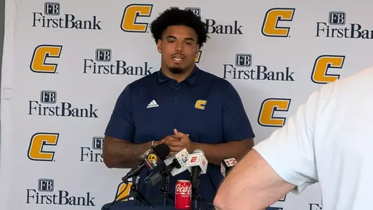 Nick Paul stands in front of the First Bank Power C media backdrop at this week's football press conference.