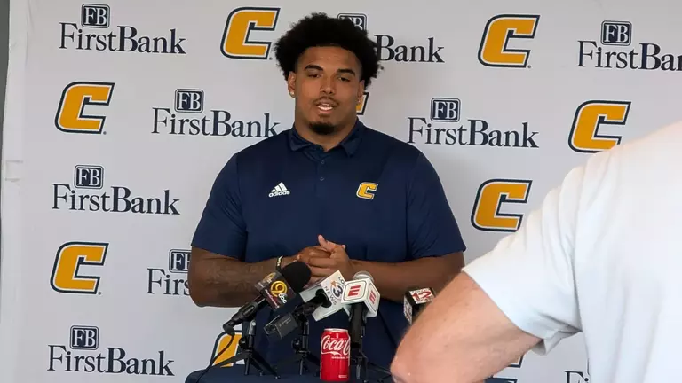 Nick Paul stands in front of the First Bank Power C media backdrop at this week's football press conference.