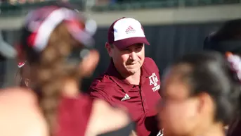 Coach Weaver in a huddle with team.