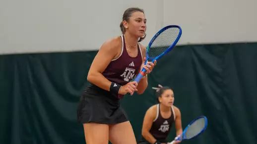 Mia Kupres awaits a service from Vanderbilt with Lucciana Perez looking on in SEC Championship quarterfinal action at Oklahoma's Headington Family Tennis Center indoor courts