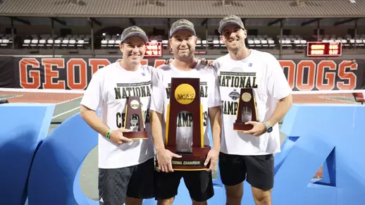 Coaches with the National Championship trophies. James Wilson, Mark Weaver and Tommy Mylnikov pose with their hardware.