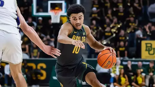 Isaac Williams driving to the basketball vs. Washington