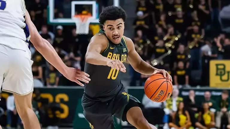 Isaac Williams driving to the basketball vs. Washington