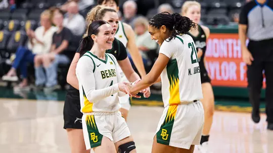 Jana Van Gytenbeek and Marcayla Johnson smile vs Le Moyne