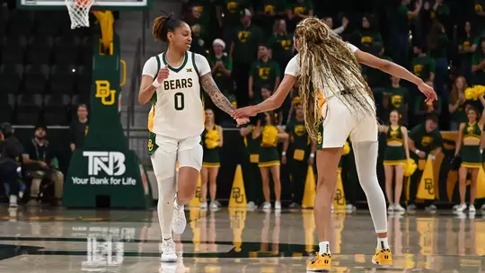 Taliah Scott and Darianna Littlepage-Buggs high five versus Southeastern Louisiana