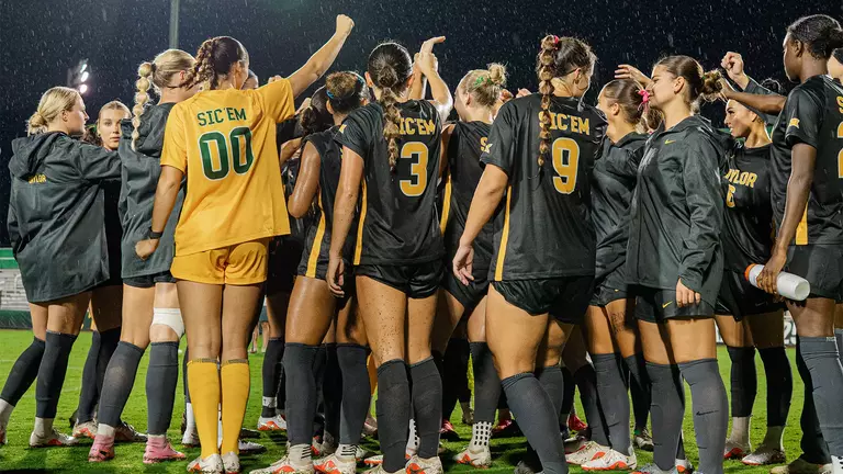 SOC team huddle postgame vs KU in the rain