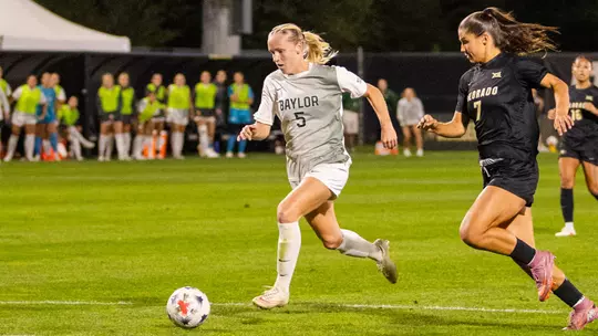Lauren Omholt dribbles at Colorado