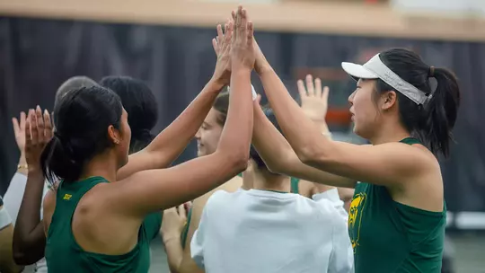 Gabby Villegas and Na Dong high five before Rice match