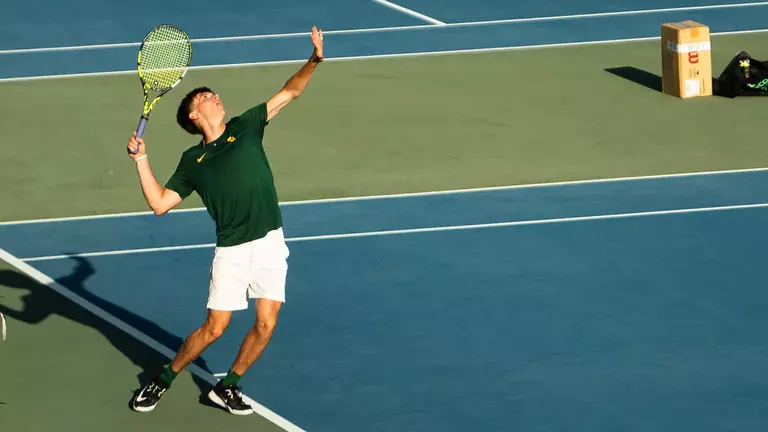 Blake Anderson serving at USTA Campus practice round